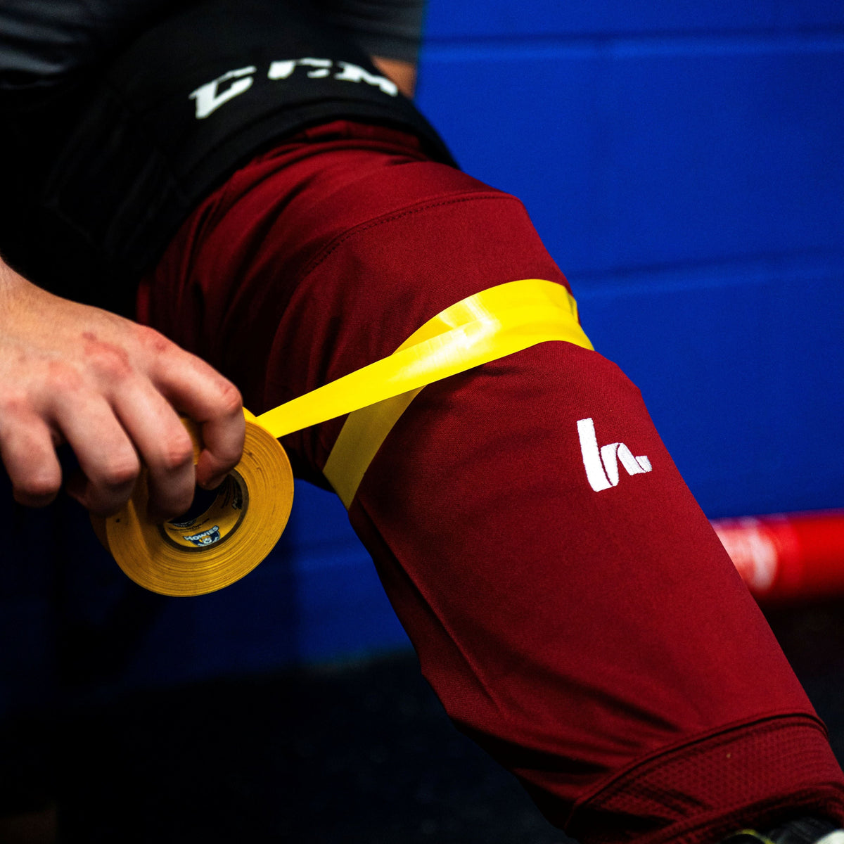 Yellow Shin Pad Tape on Maroon Sock