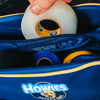 Person pulling a roll of clear tape out of  a howies accessory bag