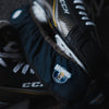Pair of hockey skates with CCM branding on a dark background