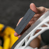 Coarse skate stone being used to sharpen a blade 