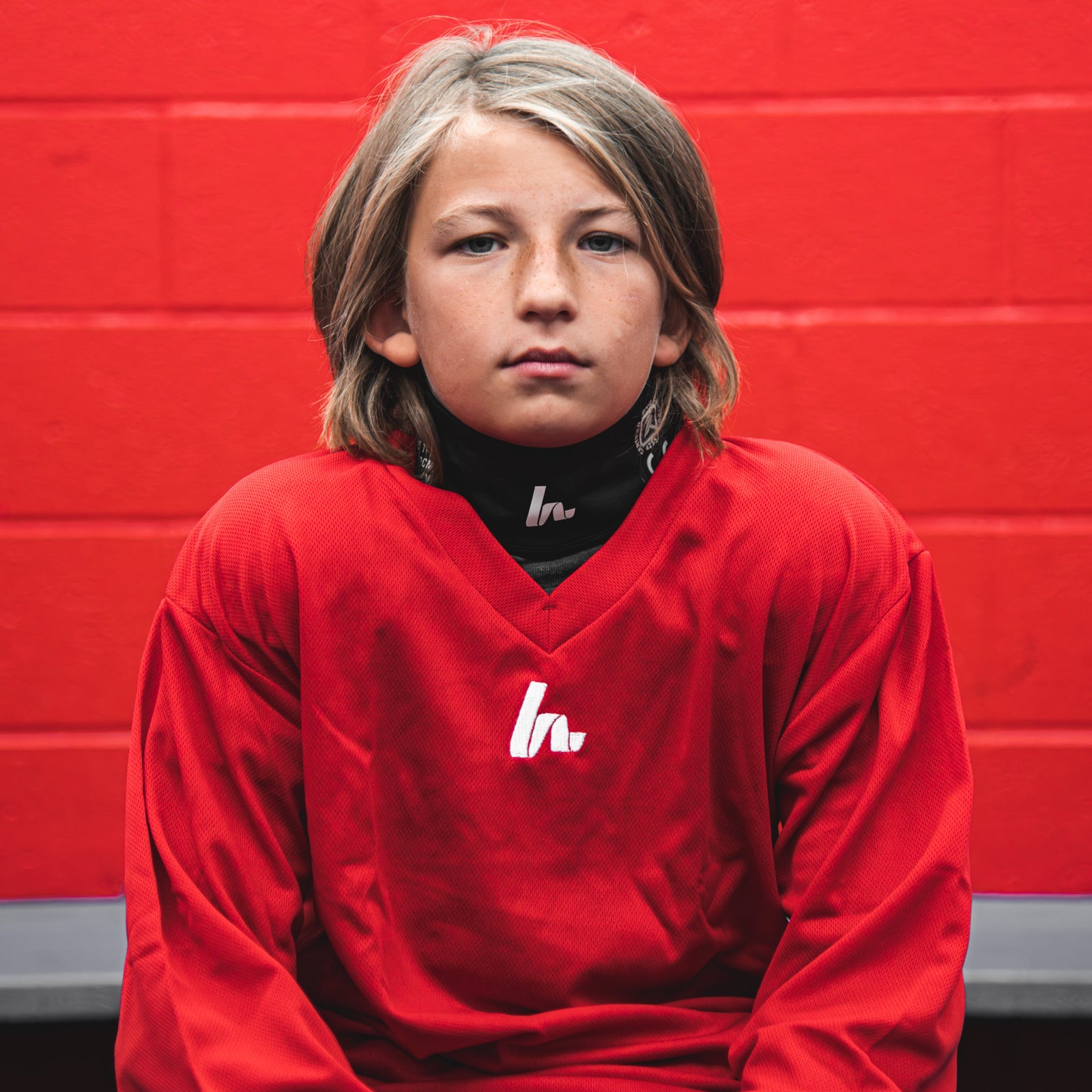 Kid in red hockey jersey
