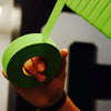 Hand holding a roll of green tape with a blurred background