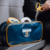 guy taking scissors out of a Howies accessory bag 