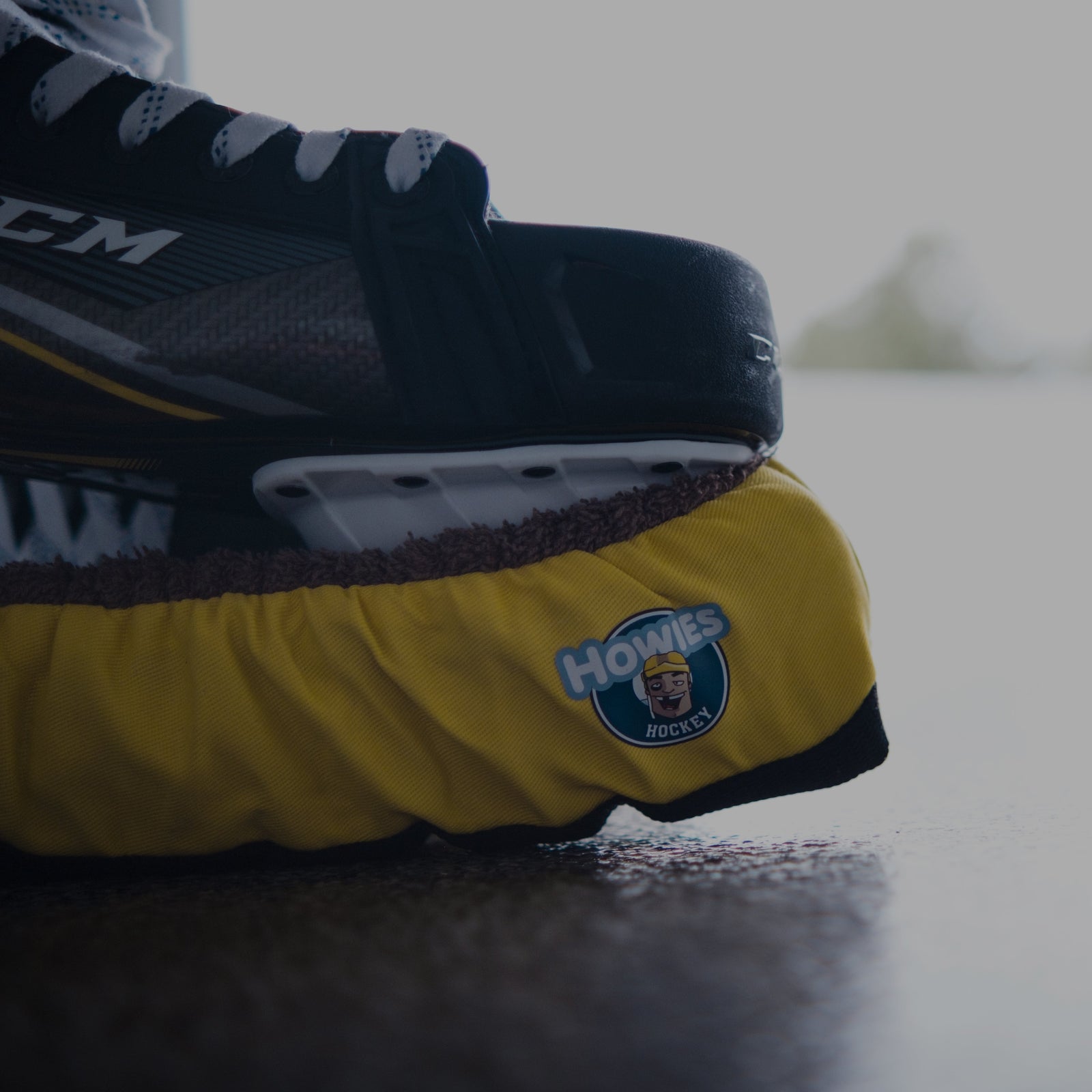 Close-up of a hockey skate with a visible brand logo on an ice rink.