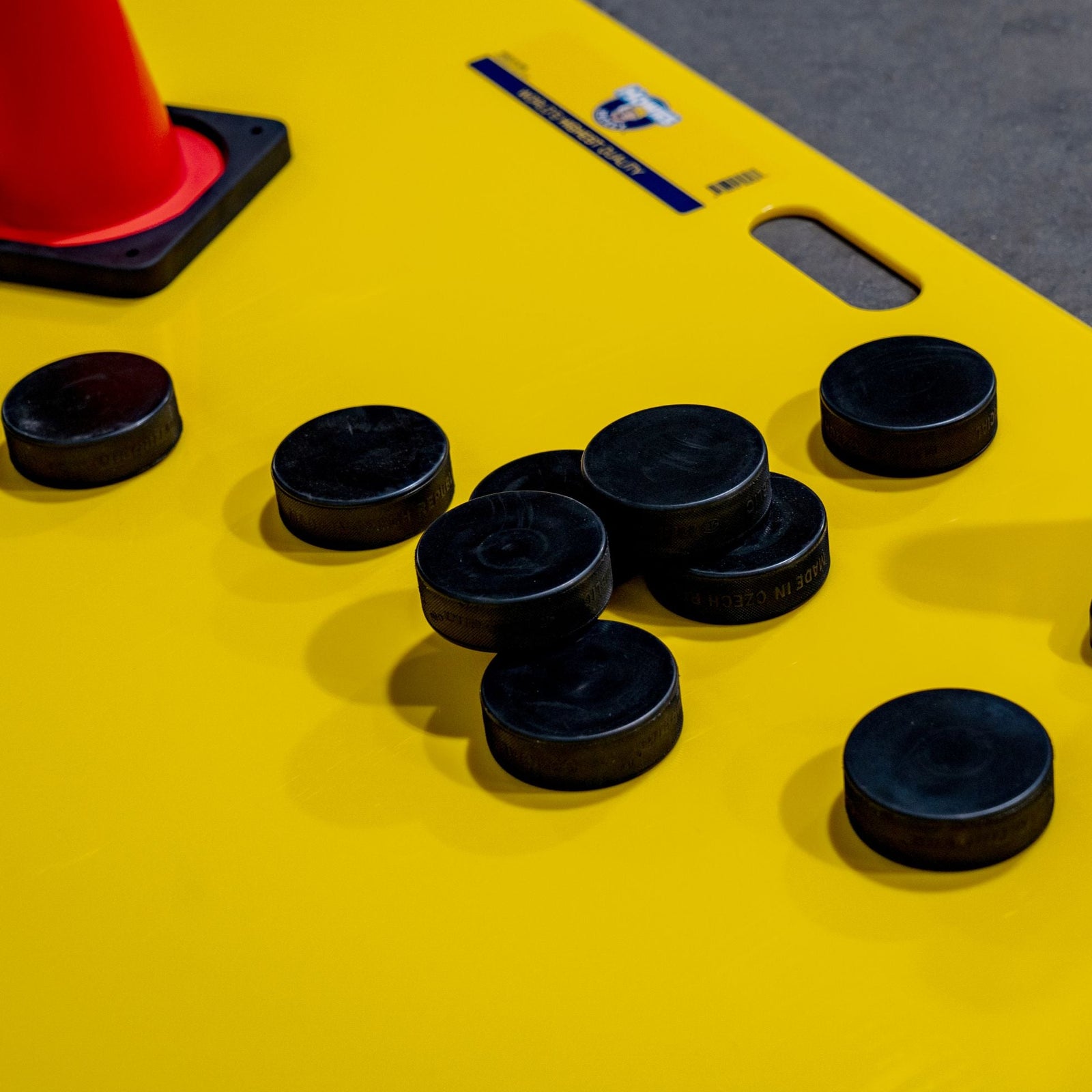 Black pucks on a shooting pad 