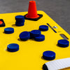 Blue pucks on a yellow shooting pad 