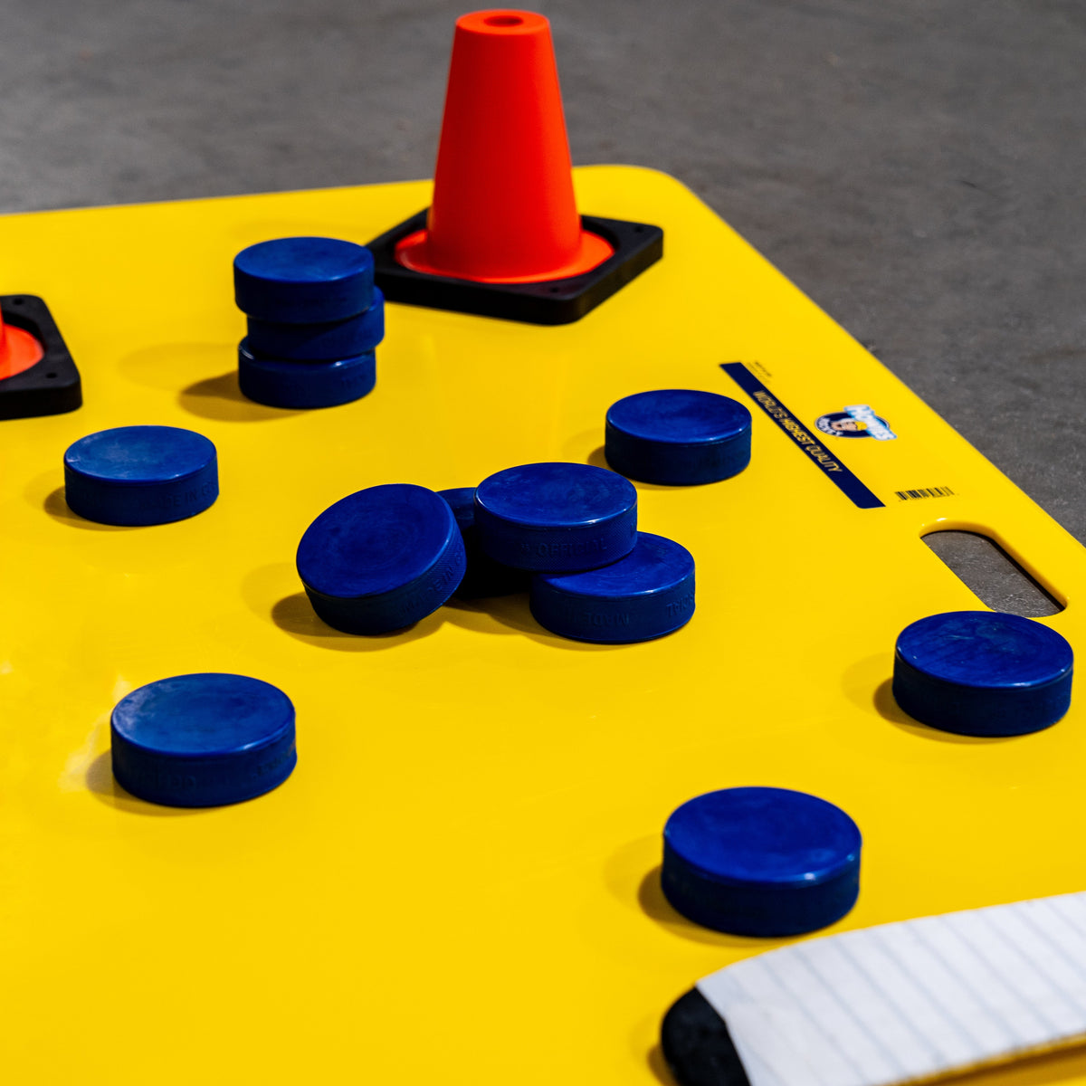 Blue pucks on a yellow shooting pad 