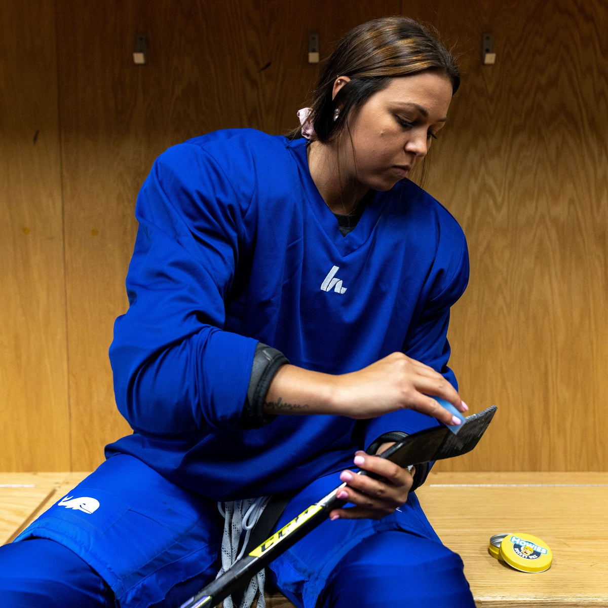 Woman wearing a blue hockey jersey 