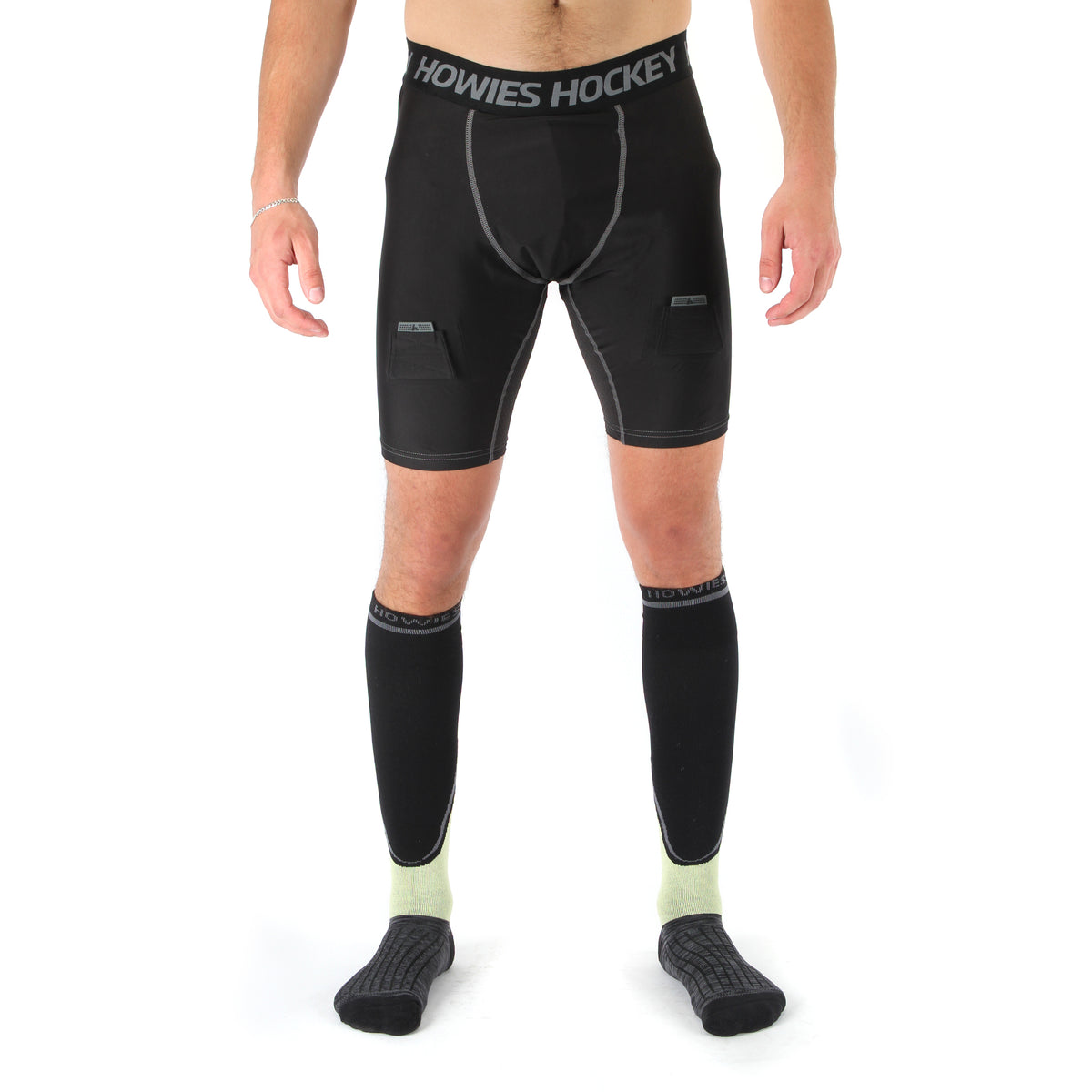Person wearing black compression shorts and socks with 'Howies Hockey' branding on a white background