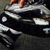 Hockey skates with 'Howies' logo held by a person